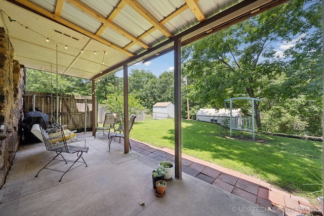 2519 W 53rd St, Tulsa, OK 74107 - view of patio / terrace featuring an outdoor structure and view of wooded area
