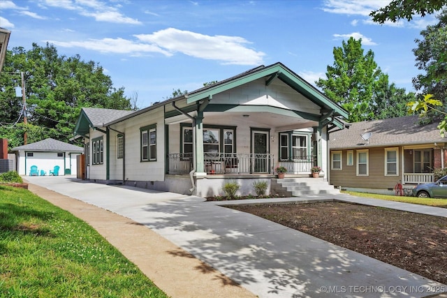 1144 S Owasso Ave, Tulsa, OK 74120 - view of front of house featuring covered porch, an outdoor structure, and a garage
