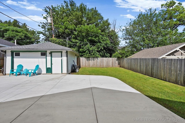 1144 S Owasso Ave, Tulsa, OK 74120 - fenced backyard featuring a patio, an outdoor structure, and a detached garage