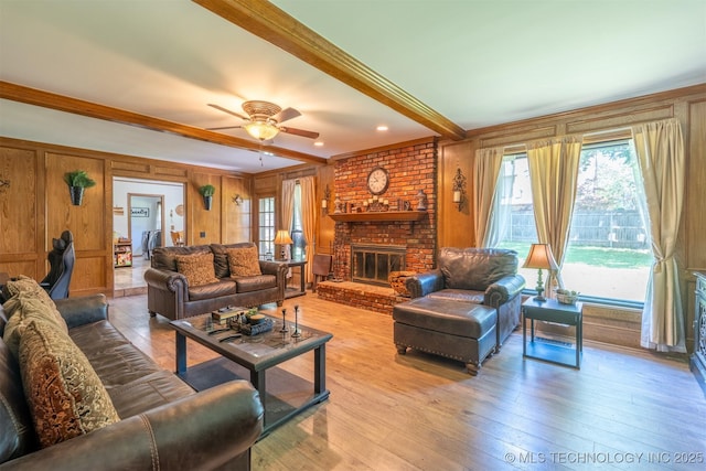 5833 E 78th Pl, Tulsa, OK 74136 - living area featuring crown molding, wood-type flooring, a fireplace, ceiling fan, and wooden walls