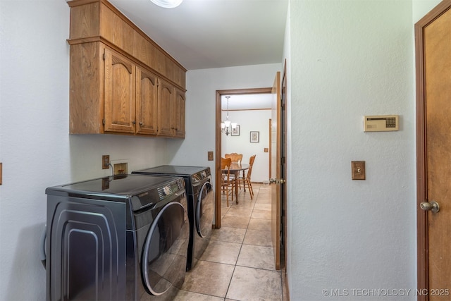 5833 E 78th Pl, Tulsa, OK 74136 - washroom with cabinet space, independent washer and dryer, light tile patterned floors, a textured wall, and a chandelier