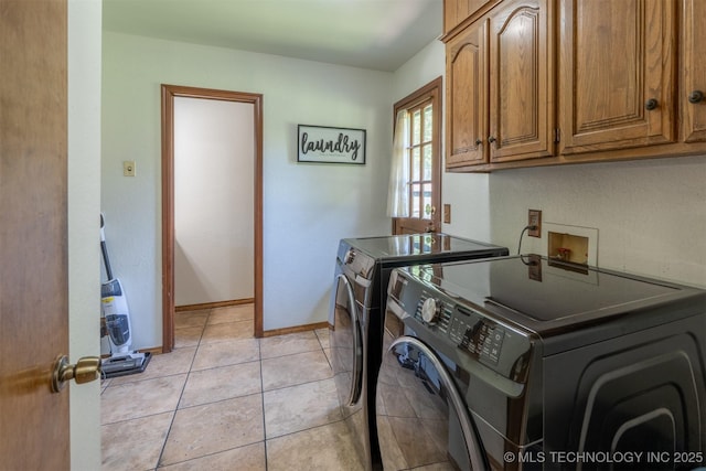 5833 E 78th Pl, Tulsa, OK 74136 - washroom with washing machine and dryer, cabinet space, and light tile patterned flooring