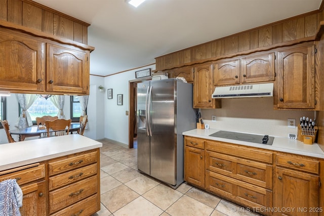 5833 E 78th Pl, Tulsa, OK 74136 - kitchen featuring stainless steel fridge, under cabinet range hood, black electric stovetop, light tile patterned floors, and brown cabinetry