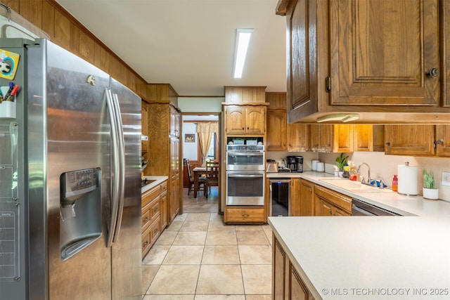 5833 E 78th Pl, Tulsa, OK 74136 - kitchen with stainless steel appliances, light countertops, brown cabinets, and light tile patterned flooring