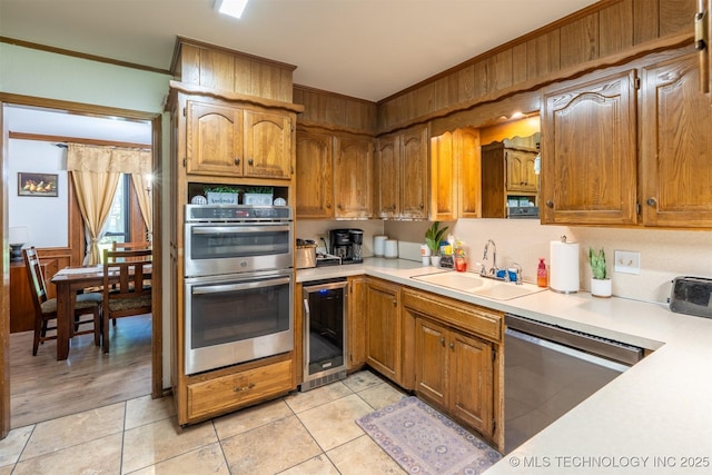 5833 E 78th Pl, Tulsa, OK 74136 - kitchen featuring stainless steel appliances, wine cooler, light countertops, ornamental molding, and light tile patterned floors