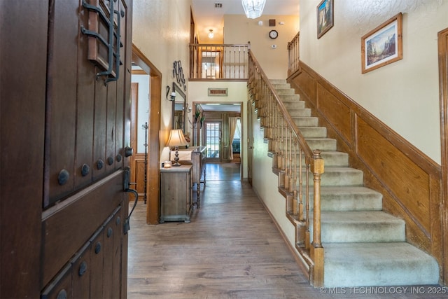 5833 E 78th Pl, Tulsa, OK 74136 - foyer entrance featuring wood finished floors, stairway, and a high ceiling