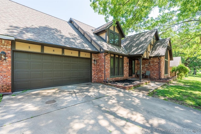 5833 E 78th Pl, Tulsa, OK 74136 - tudor house with driveway, brick siding, a garage, and a shingled roof