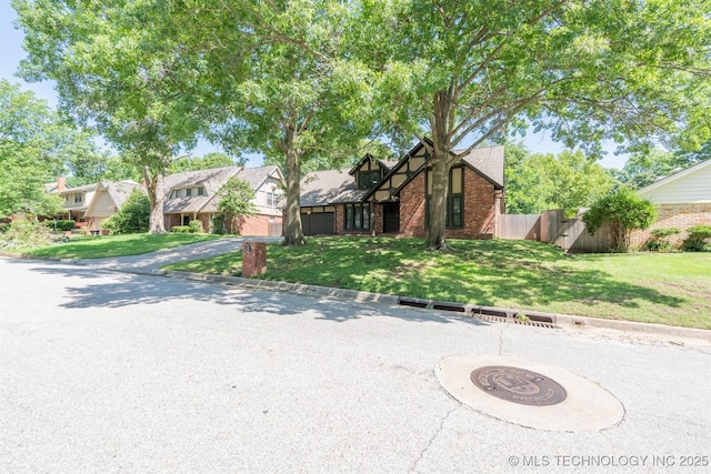 5833 E 78th Pl, Tulsa, OK 74136 - english style home featuring brick siding, an attached garage, and asphalt driveway