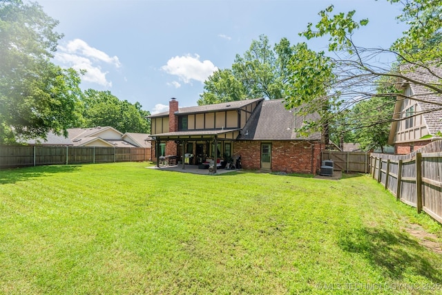 5833 E 78th Pl, Tulsa, OK 74136 - rear view of property with a fenced backyard, a patio, a chimney, brick siding, and roof with shingles