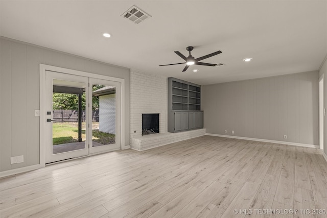 9421 S 69th E Ave, Tulsa, OK 74133 - unfurnished living room with a ceiling fan, wood finished floors, a fireplace, recessed lighting, and built in features