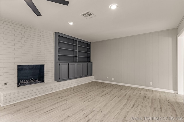 9421 S 69th E Ave, Tulsa, OK 74133 - unfurnished living room featuring wood finished floors, ceiling fan, built in features, recessed lighting, and a brick fireplace
