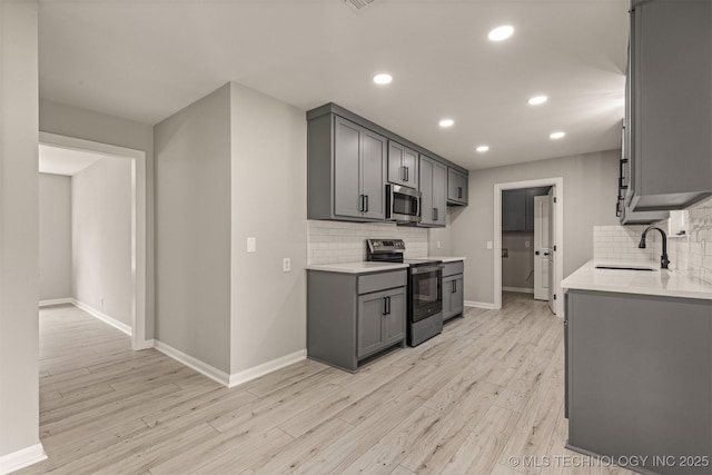 9421 S 69th E Ave, Tulsa, OK 74133 - kitchen featuring appliances with stainless steel finishes, tasteful backsplash, gray cabinetry, light countertops, and recessed lighting