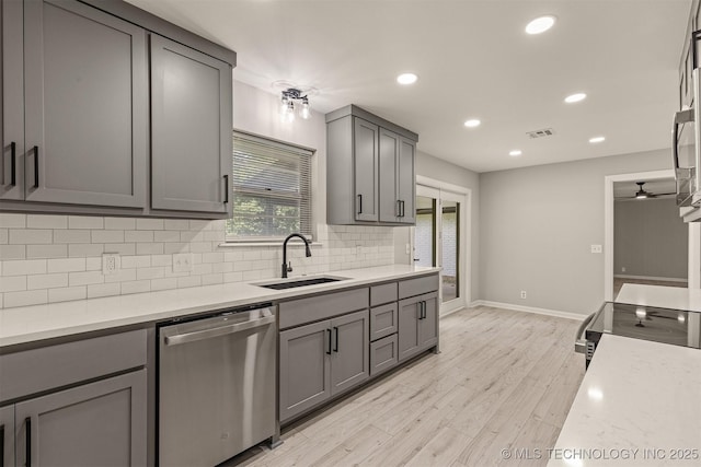9421 S 69th E Ave, Tulsa, OK 74133 - kitchen featuring appliances with stainless steel finishes, gray cabinets, backsplash, light countertops, and recessed lighting