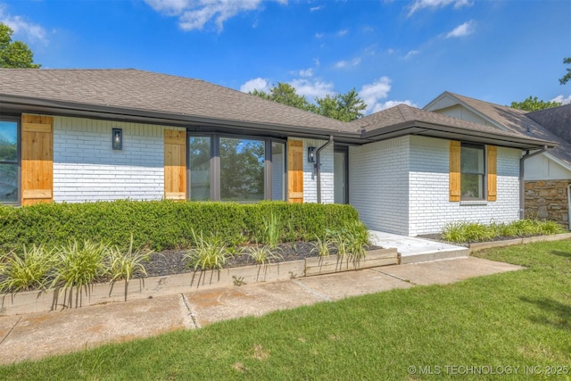 9421 S 69th E Ave, Tulsa, OK 74133 - ranch-style home with brick siding, a shingled roof, and a front yard