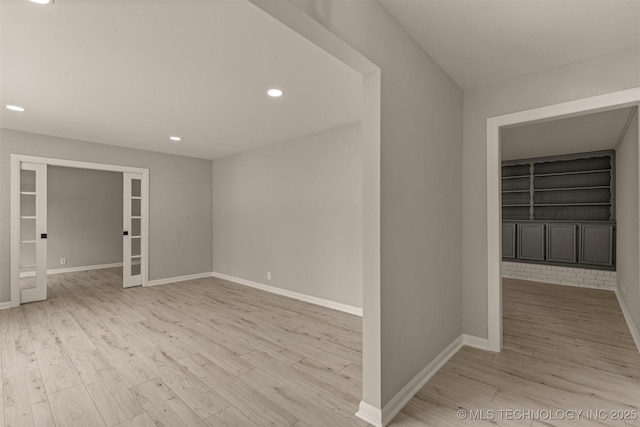 9421 S 69th E Ave, Tulsa, OK 74133 - spare room featuring wood finished floors, built in shelves, recessed lighting, and french doors