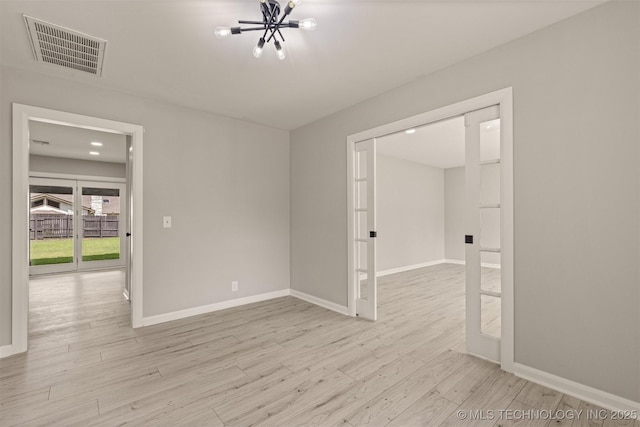 9421 S 69th E Ave, Tulsa, OK 74133 - spare room with wood finished floors, a chandelier, and recessed lighting
