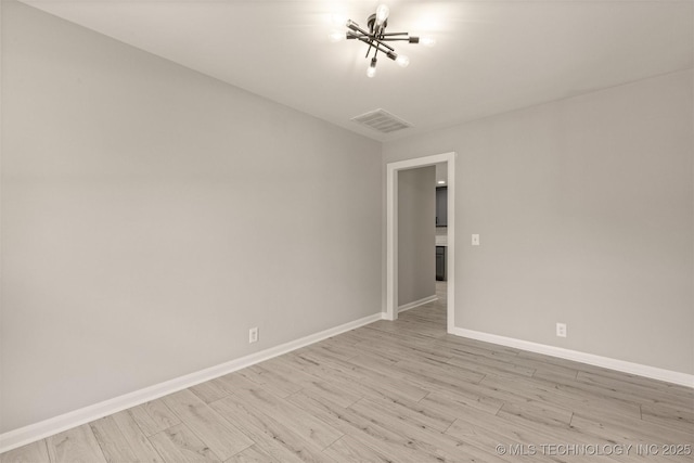 9421 S 69th E Ave, Tulsa, OK 74133 - empty room with light wood-type flooring and a chandelier