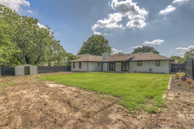 9421 S 69th E Ave, Tulsa, OK 74133 - back of property featuring a fenced backyard, a storage unit, and a chimney