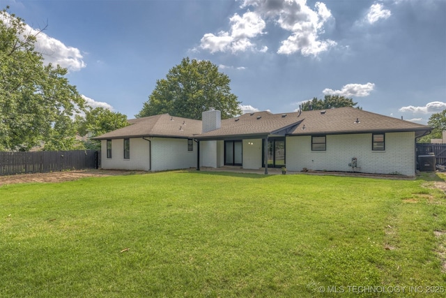 9421 S 69th E Ave, Tulsa, OK 74133 - rear view of house featuring brick siding, a chimney, a patio, and a shingled roof