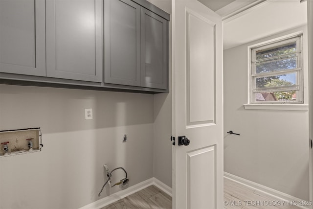9421 S 69th E Ave, Tulsa, OK 74133 - laundry area with cabinet space, electric dryer hookup, hookup for a washing machine, and light wood finished floors