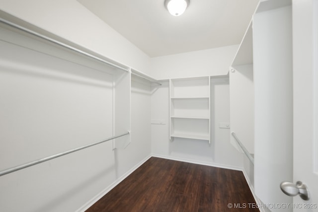 2109 W Maple St, Collinsville, OK 74021 - walk in closet with dark wood-type flooring