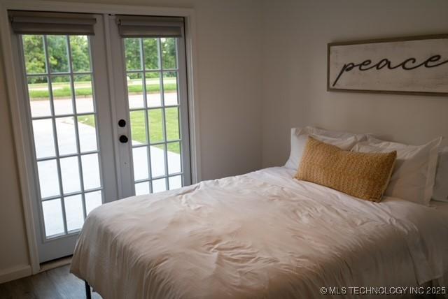 4621 Riverside Dr, Tulsa, OK 74105 - bedroom with access to outside, multiple windows, french doors, and wood finished floors