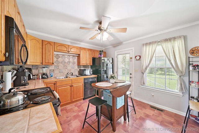 1332 E 42nd St, Tulsa, OK 74105 - kitchen with black appliances, a ceiling fan, decorative backsplash, light countertops, and crown molding