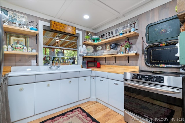 453805 E 315th Rd, Afton, OK 74331 - kitchen with stainless steel range with electric cooktop, open shelves, light wood finished floors, black microwave, and white cabinets