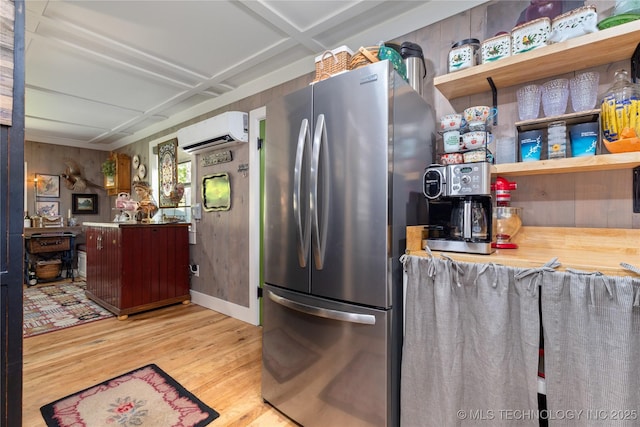 453805 E 315th Rd, Afton, OK 74331 - kitchen featuring an AC wall unit, freestanding refrigerator, light wood-style flooring, and open shelves