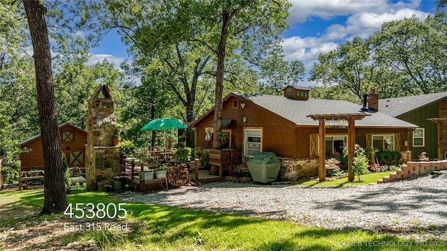 453805 E 315th Rd, Afton, OK 74331 - rear view of house featuring a chimney, an outdoor structure, and roof with shingles