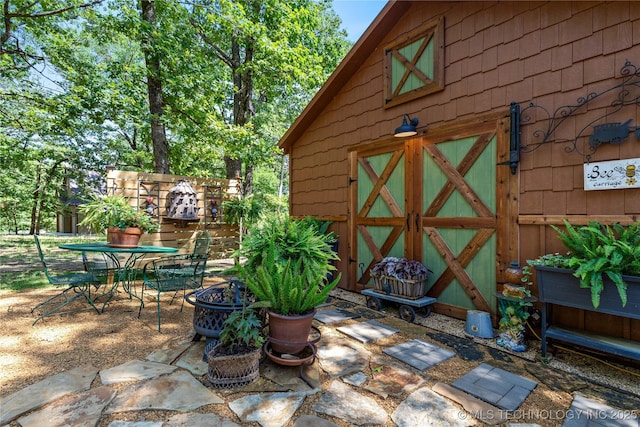 453805 E 315th Rd, Afton, OK 74331 - view of outdoor structure with a fire pit and outdoor dining space
