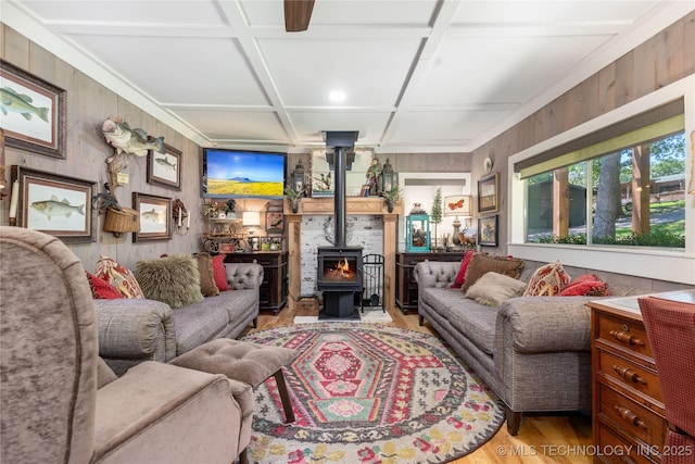 453805 E 315th Rd, Afton, OK 74331 - living area featuring light wood-type flooring, a wood stove, coffered ceiling, and wooden walls