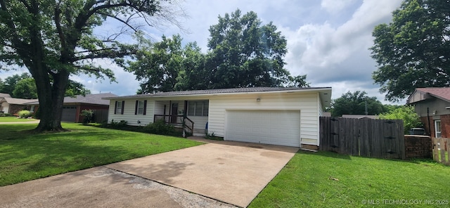 219 N Anthony St, Muskogee, OK 74403 - single story home featuring concrete driveway, a gate, an attached garage, and a metal roof