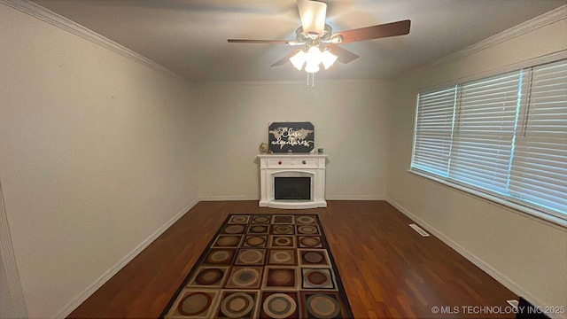 219 N Anthony St, Muskogee, OK 74403 - unfurnished living room with crown molding, ceiling fan, wood finished floors, and a fireplace with raised hearth