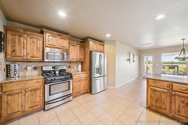 13037 N 124th E Pl, Collinsville, OK 74021 - kitchen with stainless steel appliances, decorative backsplash, brown cabinetry, recessed lighting, and light tile patterned flooring