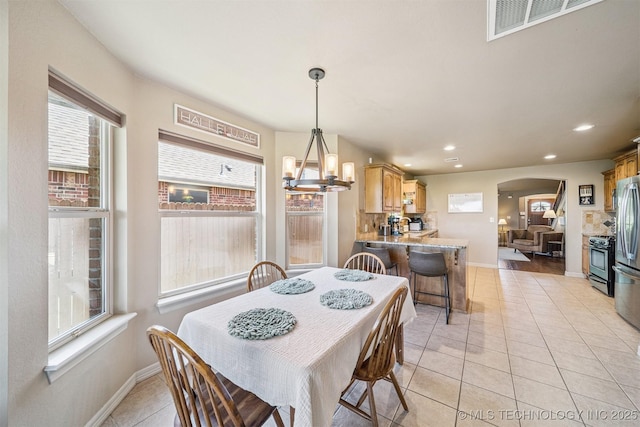 13037 N 124th E Pl, Collinsville, OK 74021 - dining room featuring arched walkways, light tile patterned floors, recessed lighting, and a chandelier