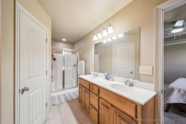 13037 N 124th E Pl, Collinsville, OK 74021 - ensuite bathroom with double vanity, a shower stall, and tile patterned floors