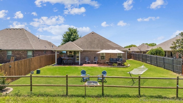 13037 N 124th E Pl, Collinsville, OK 74021 - rear view of house with a fenced backyard, an outdoor living space, brick siding, and a patio