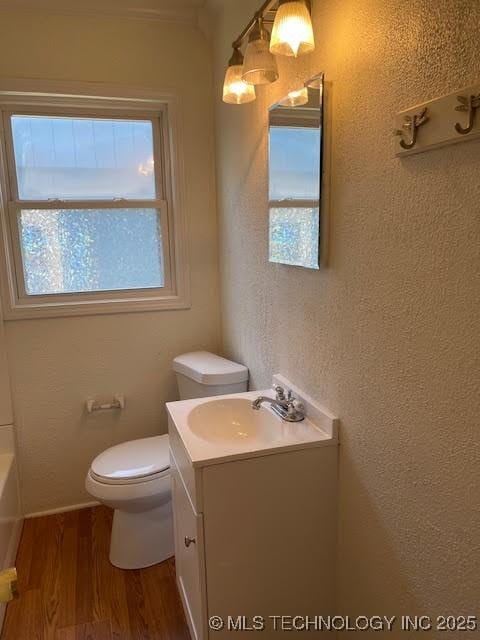 5003 S Boston Ave, Tulsa, OK 74105 - bathroom with wood finished floors, vanity, and a bath