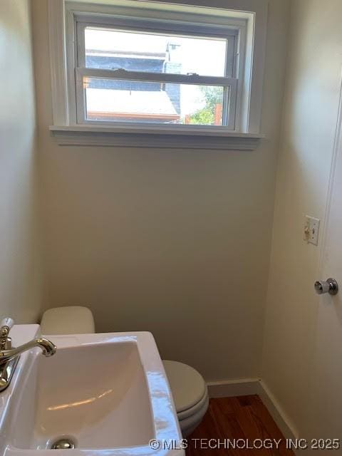 5003 S Boston Ave, Tulsa, OK 74105 - half bathroom with toilet and wood finished floors