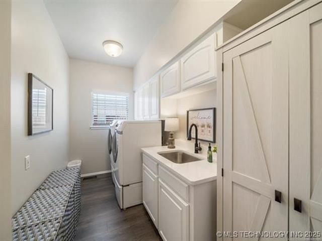 408 W Fairway Ct, Broken Arrow, OK 74011 - laundry area with independent washer and dryer, cabinet space, and dark wood finished floors