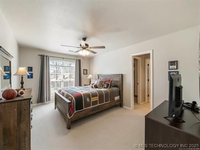 408 W Fairway Ct, Broken Arrow, OK 74011 - bedroom with light carpet and ceiling fan