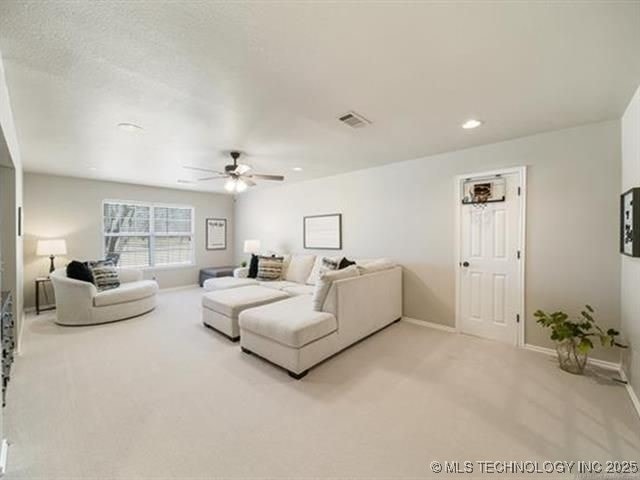 408 W Fairway Ct, Broken Arrow, OK 74011 - living room with light colored carpet, ceiling fan, and recessed lighting