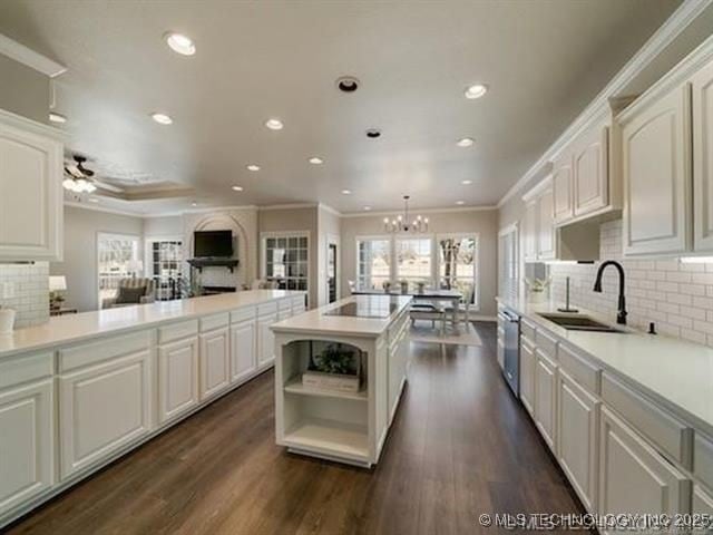 408 W Fairway Ct, Broken Arrow, OK 74011 - kitchen with crown molding, recessed lighting, backsplash, stainless steel dishwasher, and a chandelier