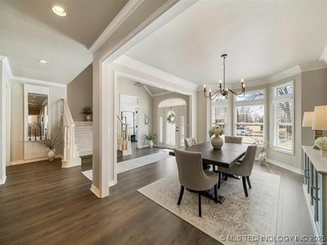 408 W Fairway Ct, Broken Arrow, OK 74011 - dining area featuring ornamental molding, a chandelier, dark wood-style flooring, recessed lighting, and arched walkways