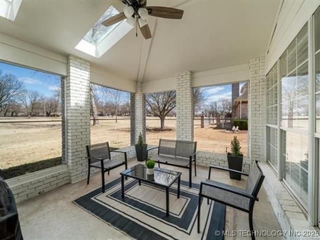 408 W Fairway Ct, Broken Arrow, OK 74011 - sunroom / solarium featuring lofted ceiling, a skylight, a ceiling fan, outdoor lounge area, and plenty of natural light