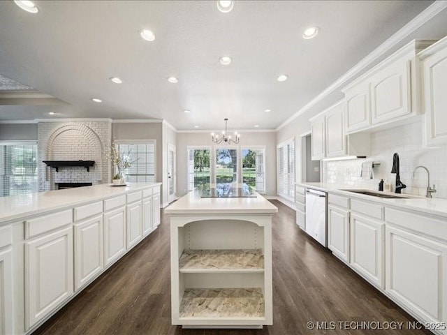 408 W Fairway Ct, Broken Arrow, OK 74011 - kitchen featuring dishwasher, black electric cooktop, a chandelier, tasteful backsplash, and a brick fireplace