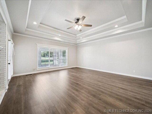 408 W Fairway Ct, Broken Arrow, OK 74011 - spare room featuring a tray ceiling, a ceiling fan, dark wood-style flooring, ornamental molding, and recessed lighting