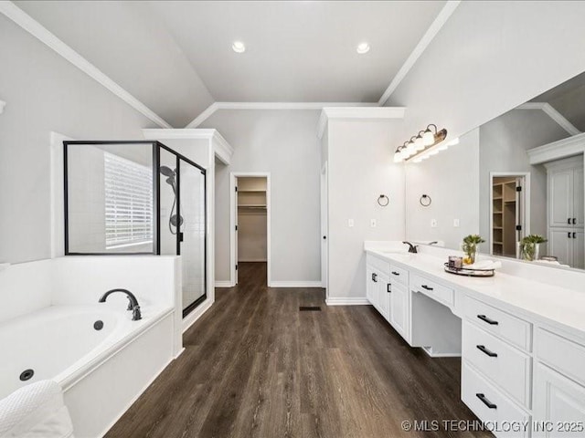 408 W Fairway Ct, Broken Arrow, OK 74011 - full bathroom featuring a spacious closet, a stall shower, wood finished floors, a garden tub, and vaulted ceiling