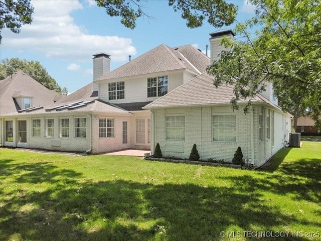 408 W Fairway Ct, Broken Arrow, OK 74011 - back of house featuring a chimney, brick siding, a lawn, and a patio